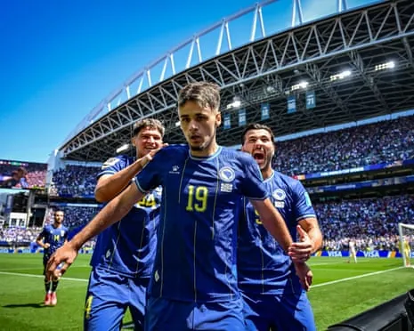 Kerim Alajbegovic races away in delight after opening the scoring for Bosnia and Herzegovina