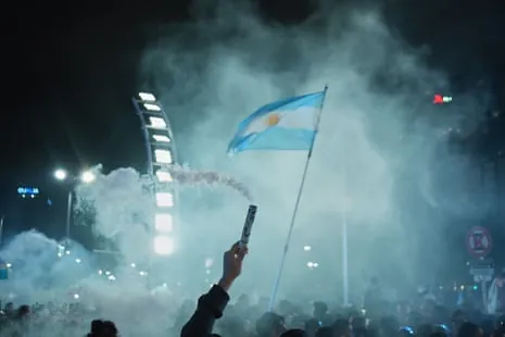 An Argentina fan sets off a smoke bomb amid celebrations in Buenos Aires