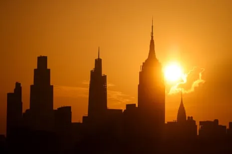 the sun behind buildings