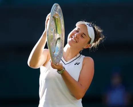 Linda Noskova holds the Wimbledon trophy after her victory in the women's singles final