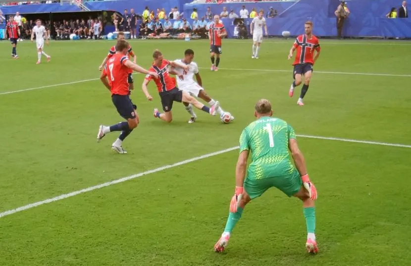 Jude Bellingham fires the ball past Norway's goalkeeper Orjan Nyland to draw England level.