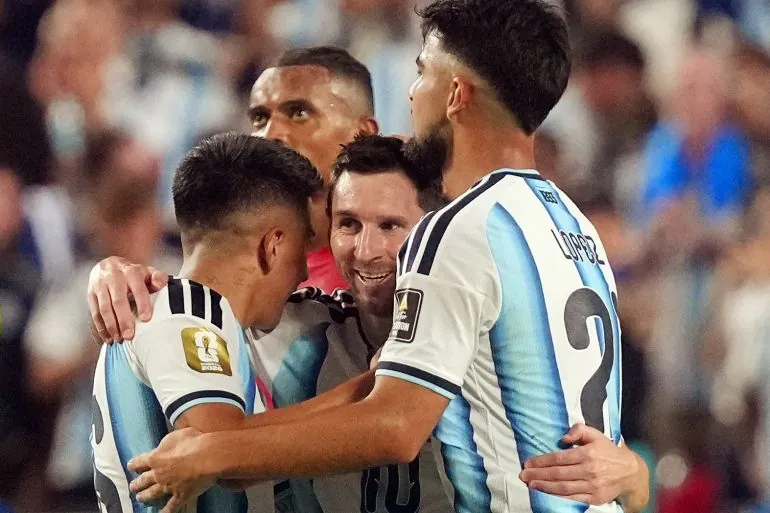 Argentina's Lionel Messi celebrates after the match with Jose Manuel Lopez